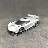 White diecast sports car with black wheels, tinted windows, and yellow racing stripe
