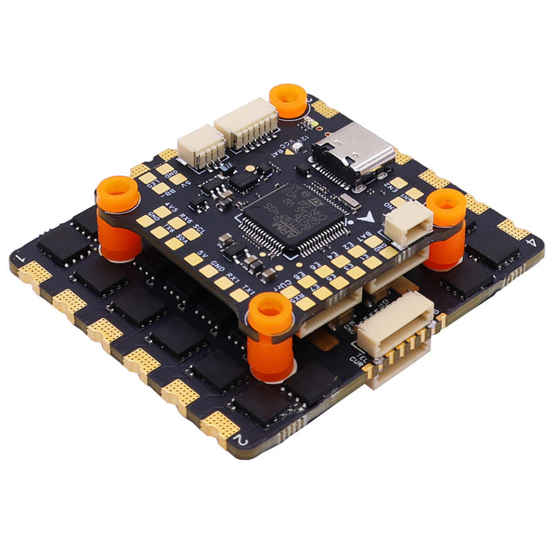 FPV flight controller circuit board with orange connectors and dark PCB