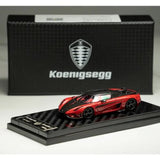 1:64 scale red Koenigsegg Regera diecast model car on black display base.
