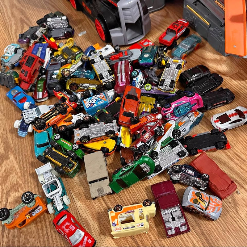 Assorted diecast toy cars and trucks, colorful metal vehicles in a mixed lineup