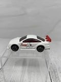White Coca-Cola diecast toy car with black wheels on clear display base, rear view