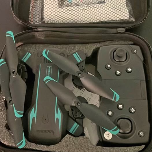 GPS drone with folded propellers and control panel in storage case