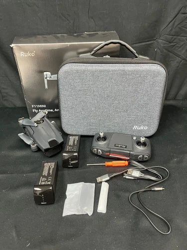Black mini drone kit with remote, case, batteries, propellers and charging accessories