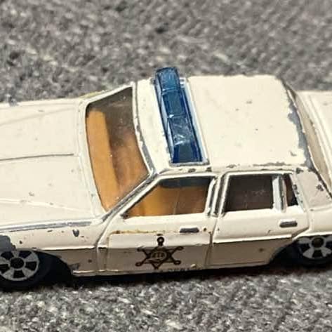ERTL replica diecast car, side view, cream body with blue detail, black wheels