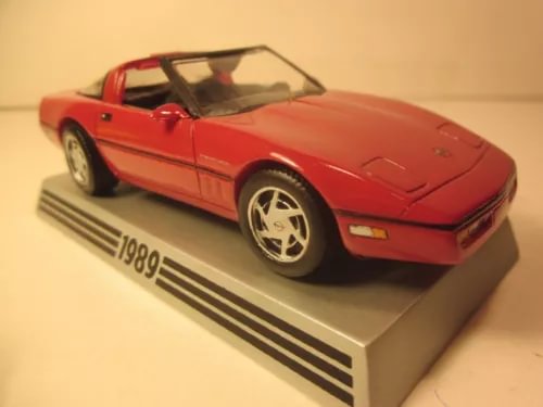 Red diecast model Corvette coupe with silver wheels and black windshield.