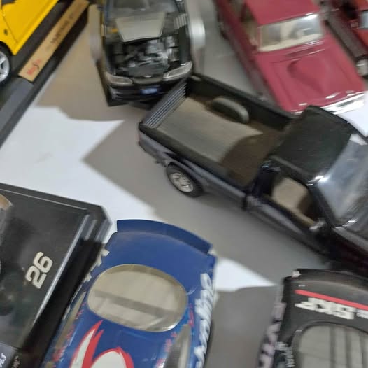 Diecast metal toy cars set with blue and black vehicles, open windows