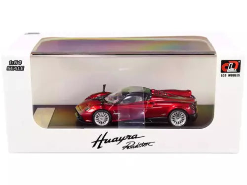 Red metallic diecast model roadster car with silver wheels in display box