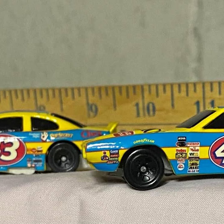 Yellow and blue #63 diecast race car model, front three-quarter view.