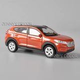 Orange diecast model SUV car with pull-back action, 1:36 scale, front three-quarter view
