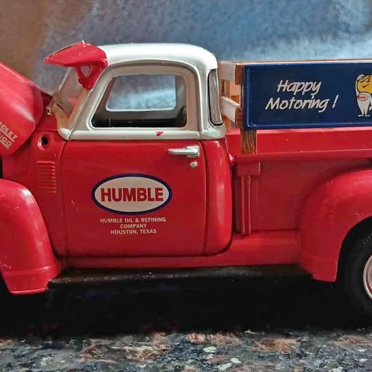 1:25 scale red and white 1950 Chevy pickup diecast by ERTL, front cab and Humble door
