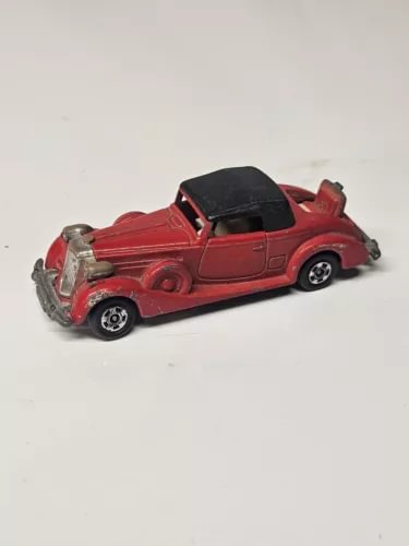 Red diecast coupe roadster with black roof and silver side detailing