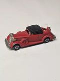 Red diecast coupe roadster with black roof and silver side detailing