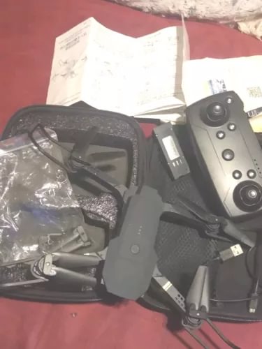 Foldable black drone with front camera module and folded arms