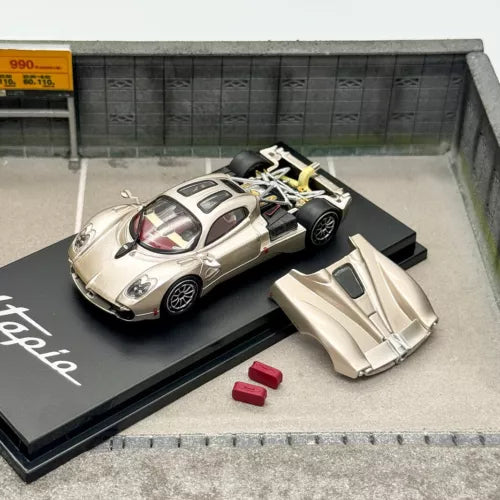 Diecast sports car model set with silver car, gold accents, and spare parts.