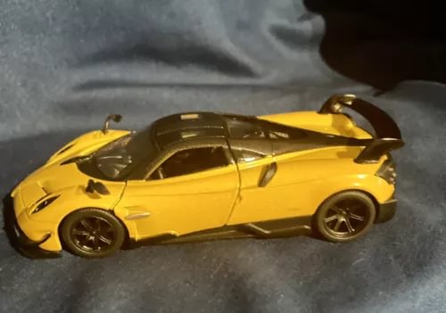 Yellow diecast pullback sports car, side view with black wheels.