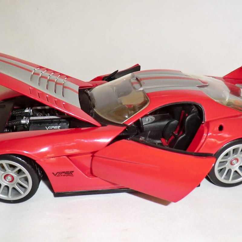 Red and silver 1:18 diecast sports coupe with open hood and detailed interior.