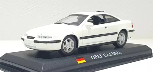 White diecast sports car model with black side stripe, OPEL CALIBRA label on base