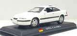 White diecast sports car model with black side stripe, OPEL CALIBRA label on base