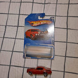 Hot Wheels 1:64 scale diecast car in red, in blister pack