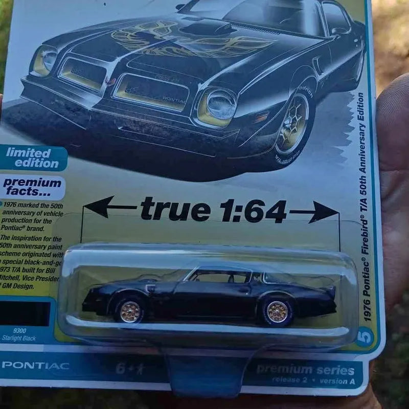 Pontiac Firebird diecast model car, dark blue, 1:64 scale.