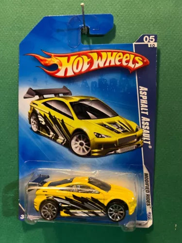 Hot Wheels diecast car in blister pack, yellow and black with flames