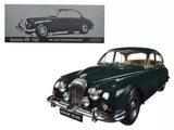 Diecast model car of a classic dark green 1960s sedan, front three-quarter view