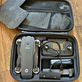 Open hard-shell drone case with gray quadcopter, controller, and cables