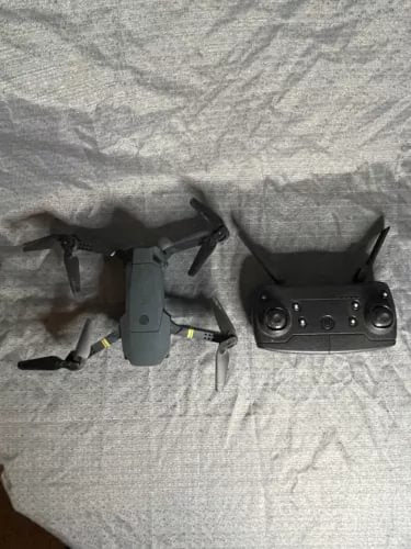 Quadcopter drone with remote controller, front view
