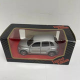 Silver diecast car model in retail box with clear window