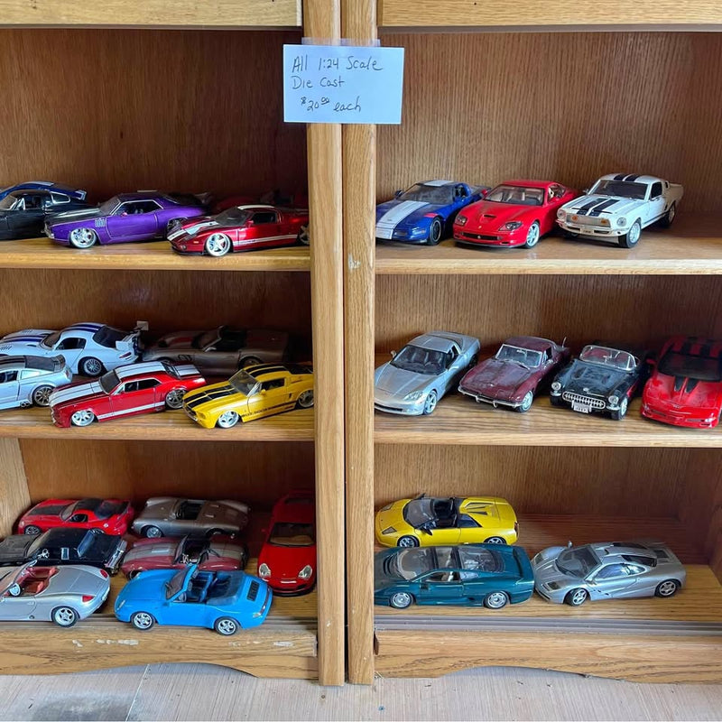 Assorted diecast toy cars, colorful sports coupes in 1:24 and 1:18 scale.