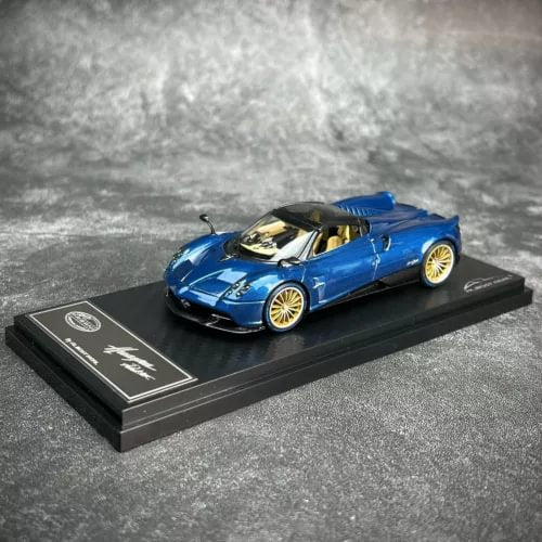 Almost Real diecast sports car model, blue convertible on black display base