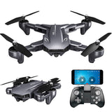 Black quadcopter drone with four propellers, foldable arms, and front camera module