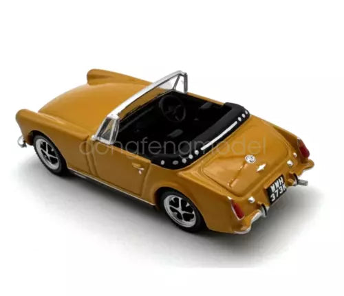 Yellow diecast metal convertible sports car model with black interior and open cockpit
