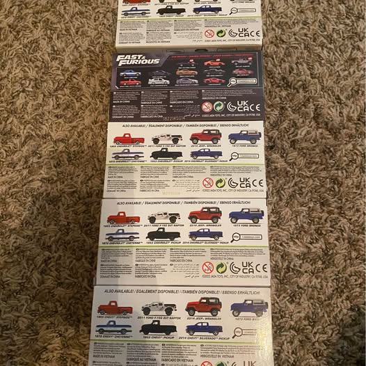 Diecast truck set box showing multiple truck models and safety labeling