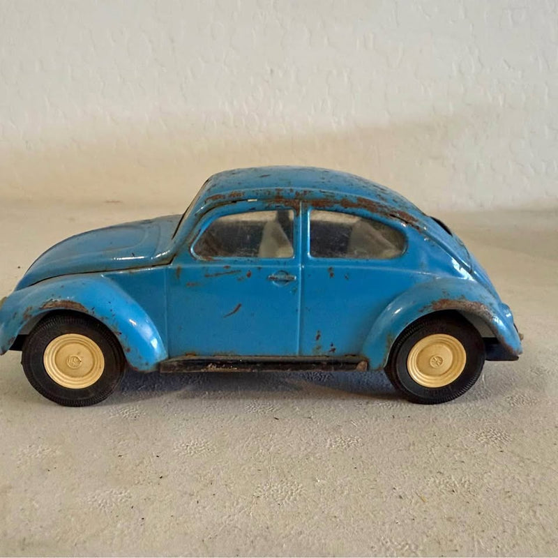 Tonka diecast Beetle car, blue with beige wheels, side profile view
