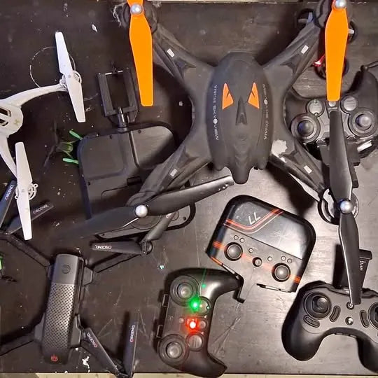 Drone bundle with multiple quadcopters, remote controllers, and propellers
