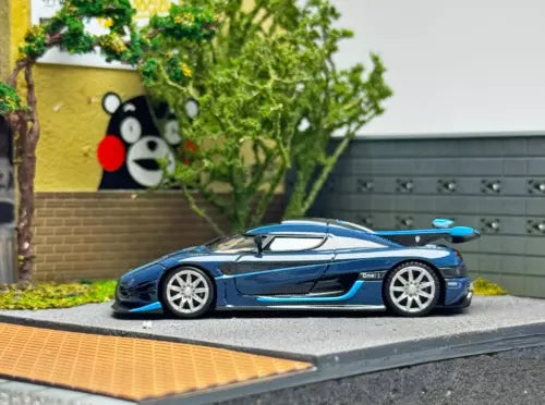 Blue sports racing diecast model car, side view with white wheels