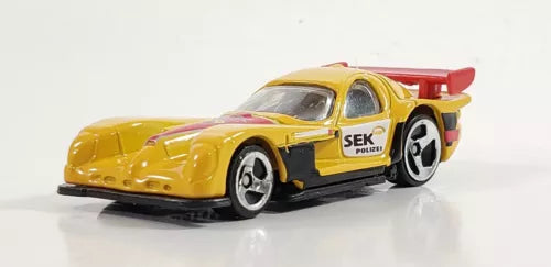 Yellow diecast race car model with red rear spoiler and black side trim