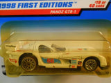 Cream diecast race car toy in clear blister pack, black wheels