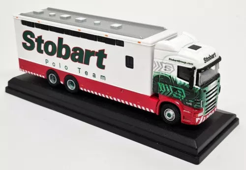 Diecast horsebox truck with white cab and red-and-white Stobart trailer, on display base