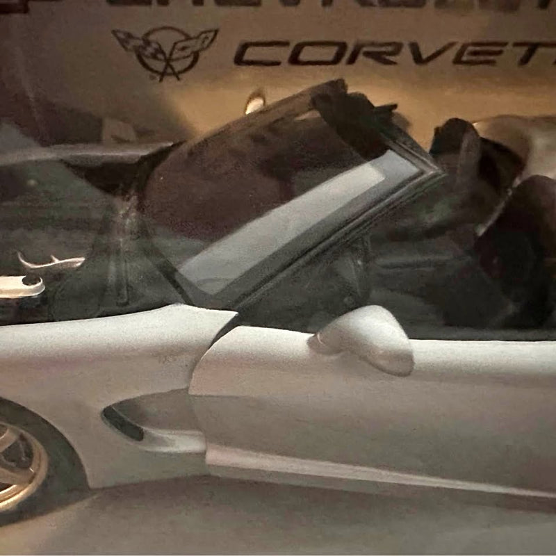 White die-cast Corvette C5 model car, front side view with detailed wheel
