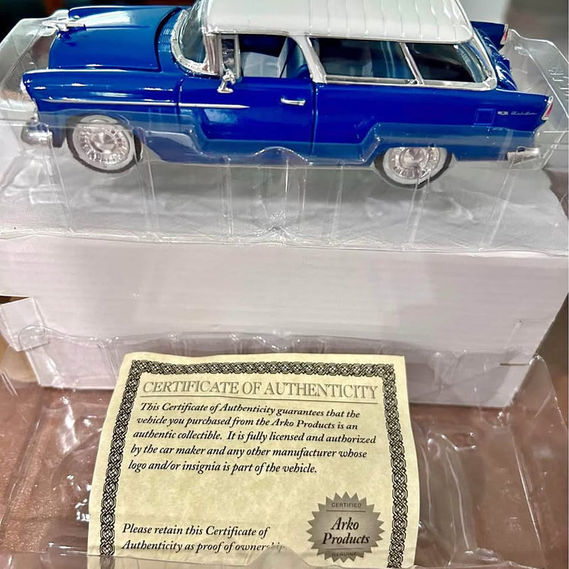 Blue diecast 1955 Chevy Nomad hardtop car model with authenticity certificate