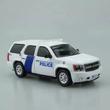 Police SUV diecast model car, white body with blue stripe, front 3/4 view
