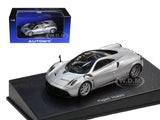 Metallic silver diecast model car with black roof, on display base