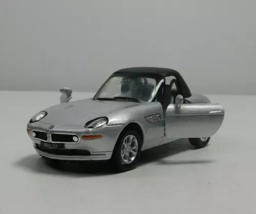 Silver diecast sports car with rear wing and open driver-side door