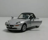 Silver diecast sports car with rear wing and open driver-side door