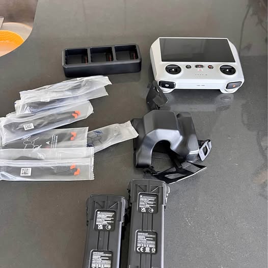 DJI Mavic remote controller with two batteries, propeller spares, and storage case
