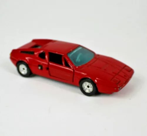 Red vintage diecast sports car model, black hood vents and side details
