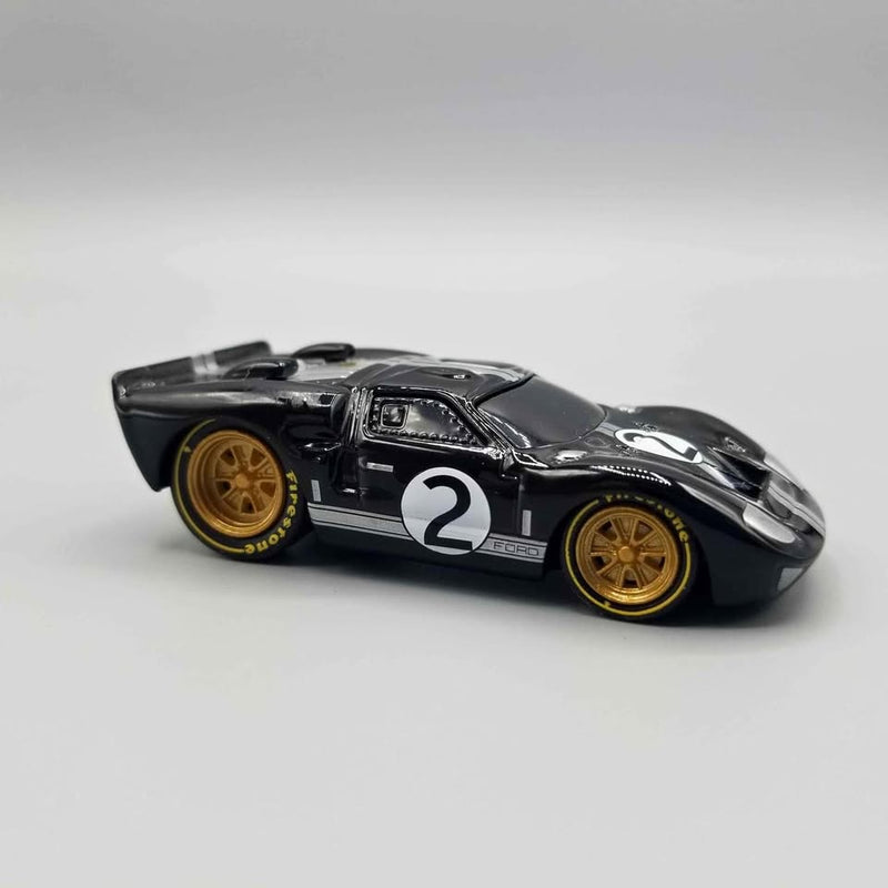 Black diecast race car model, number 2, gold wheels