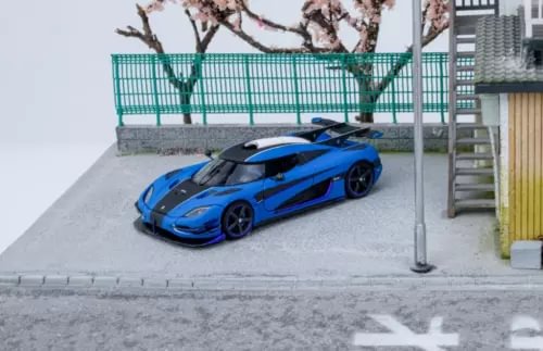 Blue sports diecast model car with black wheels, front 3/4 view.